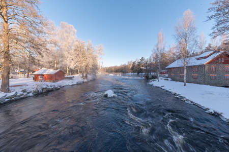 sunrise over water at Knappforsen Lunedet near Karlskoga Swedenの写真素材