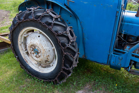 tires on a blue tractor standing i gras