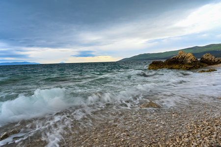 waves coming and going on a pebbely beach