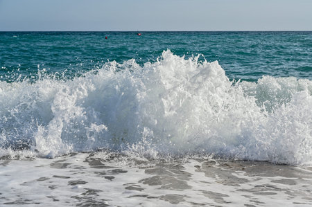 waves in mediterranean sea hitting the beach
