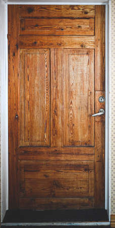 old brown wooden front door in a cabinの写真素材