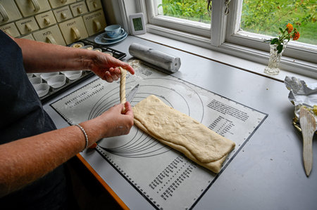 person making home made cinnamon and vanilla buns