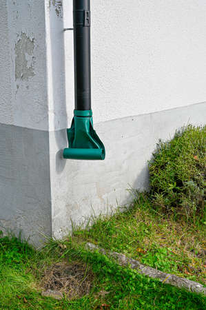 metal downpipe with plastic outomatic roll at houseの写真素材