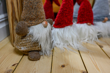 small Santas made of cloth standing on wooden floorの写真素材