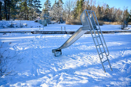 slide at a bathing place covered in snow february 2021の写真素材
