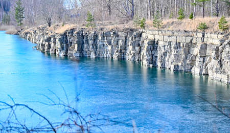 overlooking old open pit with frozen iceの写真素材
