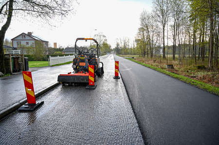 road worker laying asphalt on road in Swedenのeditorial素材