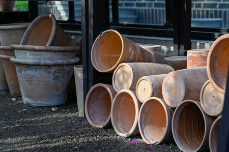 handmade crockpots piled inside a public greenhouseの写真素材