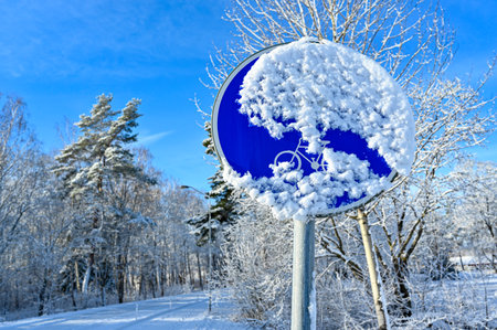 traffic sign for walking and bicycle path coverde in snowの写真素材
