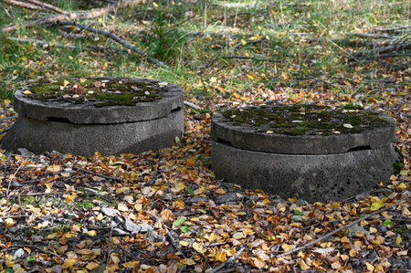 two wells made of cement with lids on