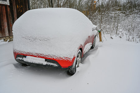 red car covered in snow Sweden january 6 2023の写真素材
