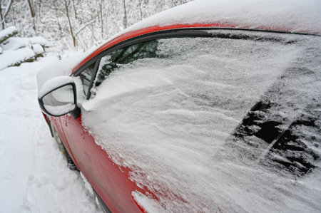 red car covered in snow Sweden january 6 2023の写真素材
