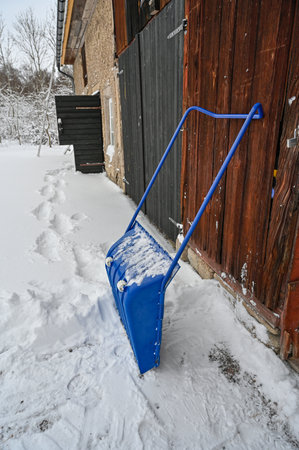 big blue plastic shovel taking care of snow in Swedenの写真素材