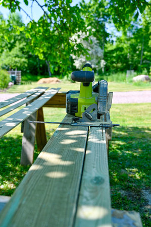 cirecle saw on planks in summer gardenの写真素材