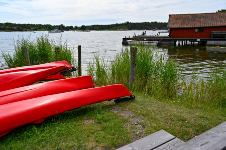 Looking over red kayaks into Nykoping archepelago Swedenの写真素材