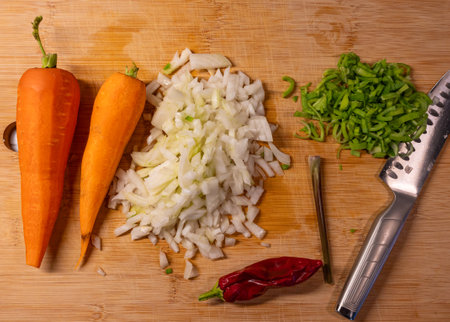 Different vegetables and knife on bamboo cutting boardの写真素材