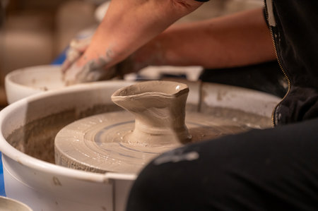 Potters wheel with hands forming clay to artの写真素材