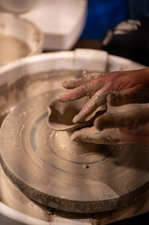Potters wheel with hands forming clay to artの写真素材