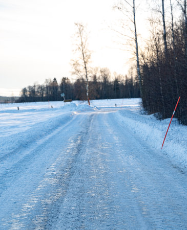 Snowy and icy road that is plowed and covered in gritの写真素材