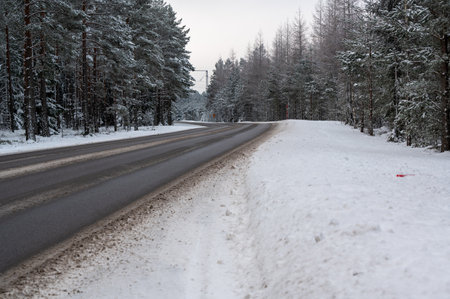 Winter road through forest in Hallsberg Swedenの写真素材