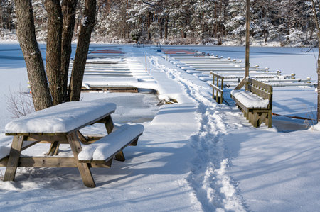 Foot prints in snow out on wooden jettyの写真素材