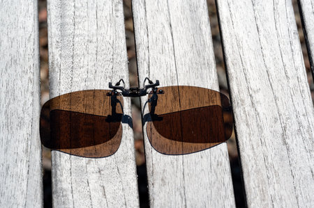Brown clip on sunglasses on wooden tableの写真素材