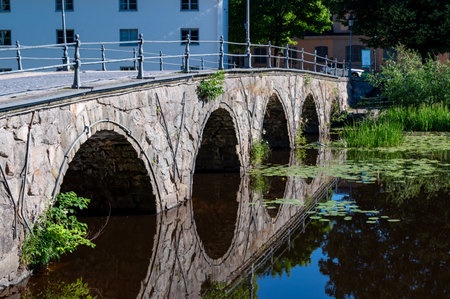 Old arch bridge made of stones in Orebro city center Swedenの写真素材