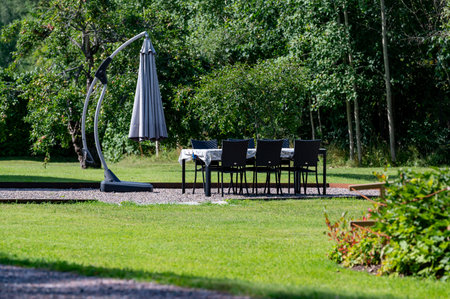 Garden furniture standing on gravel in beautiful gardenの写真素材