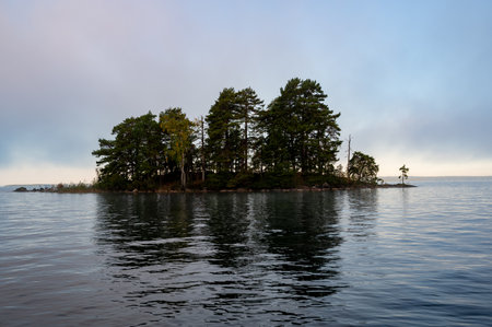 Small island a calm morning in Lake Vattern Motala Swedenの写真素材
