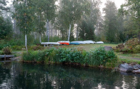 boats lying upside down near lake Vattern Motala Swedenの写真素材