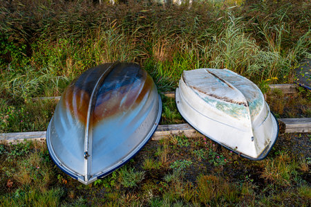 Two small boats upside down on logsの写真素材