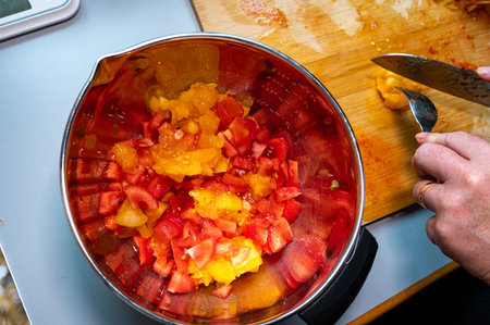 Bowl with peeled and cut tomatoes in kitchenの写真素材