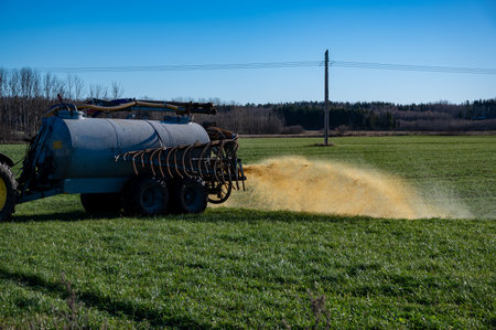 farmer spreads manure on farmland Hallsberg Swedenの写真素材