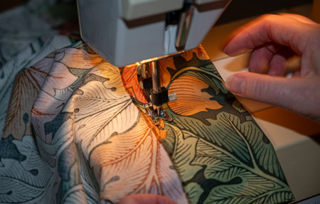 Woman working at home with sewing machineの写真素材