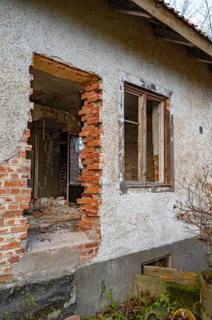 Old house with big hole in brick wallの写真素材
