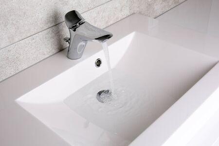 Water flowing to the sinkの写真素材