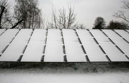 Photovoltaic panels covered with snow on a snowy dayの写真素材
