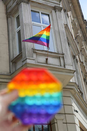 Baby toy in LGBT colors and flag in the backgroundの写真素材