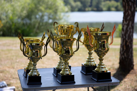 Tropy cups in a park on a background of a lake.