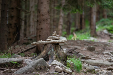Stone pyramid in the forest. Zen and meditation concept. Selective focusの写真素材