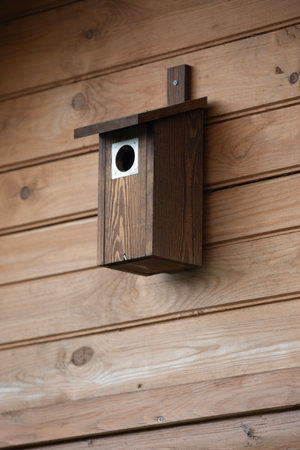 Wooden birdhouse on the wall of a wooden house in Japan