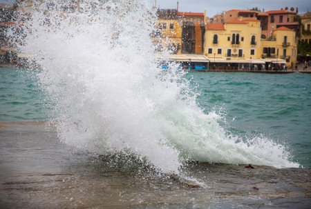 Splashes of the sea against the background of the old town.の写真素材