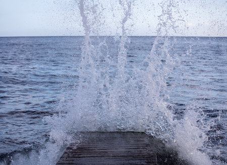 Splashes of water from the jetty on the Black Sea.の写真素材