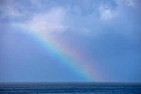Rainbow over the sea in stormy weather, natural background.