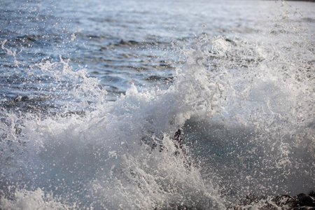 Ocean waves splashing on the shore of Madeira Island in Portugal