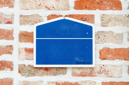 Wooden signboard on brick wallの写真素材