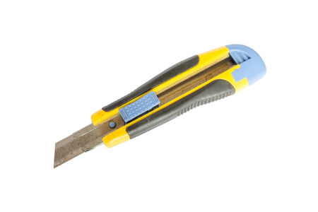 Yellow box cutter with rusty blade isolated on white backgroundの写真素材