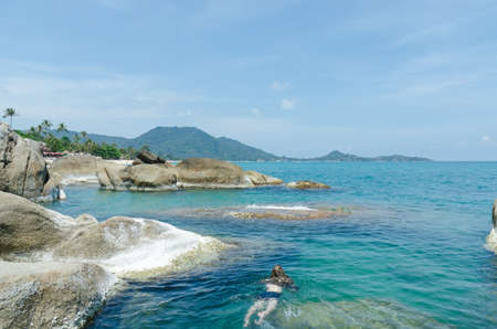 A man swimming in the sea at lamai beach samui suratthani thailandの写真素材