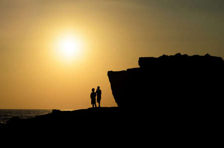 Silhouette people view sunset from mountainの写真素材