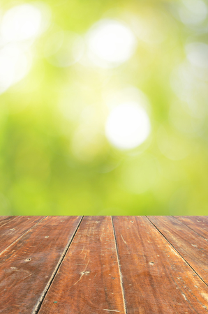 Empty wood table and green bokeh abstract background ,can be used for display your productsの写真素材